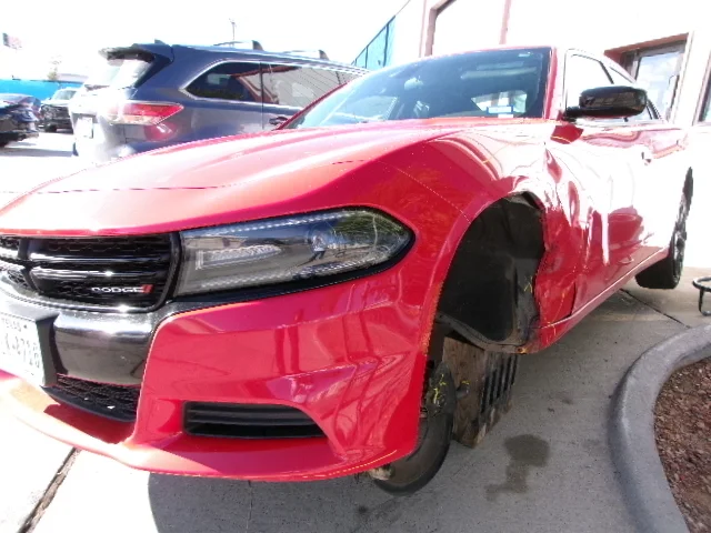 Red Charger fender damage before repair